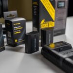 Nitecore battery and charger kit displayed on a desk, ideal for photography equipment setups.