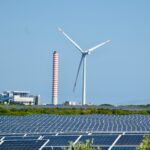 A wind farm with a wind turbine in the background